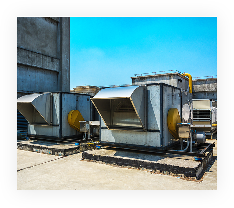 Two large industrial air conditioners on a building.